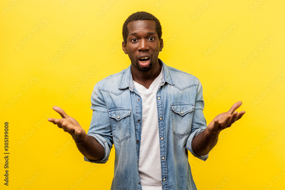 How could you. Portrait of unpleasantly surprised man in denim casual shirt standing with raised hands and amazed face asking why'd you do that, indignant annoyed expression. indoor studio shot How could you. Portrait of unpleasantly surprised man in denim casual shirt standing with raised hands and amazed face asking why'd you do that, indignant annoyed expression. indoor studio shot