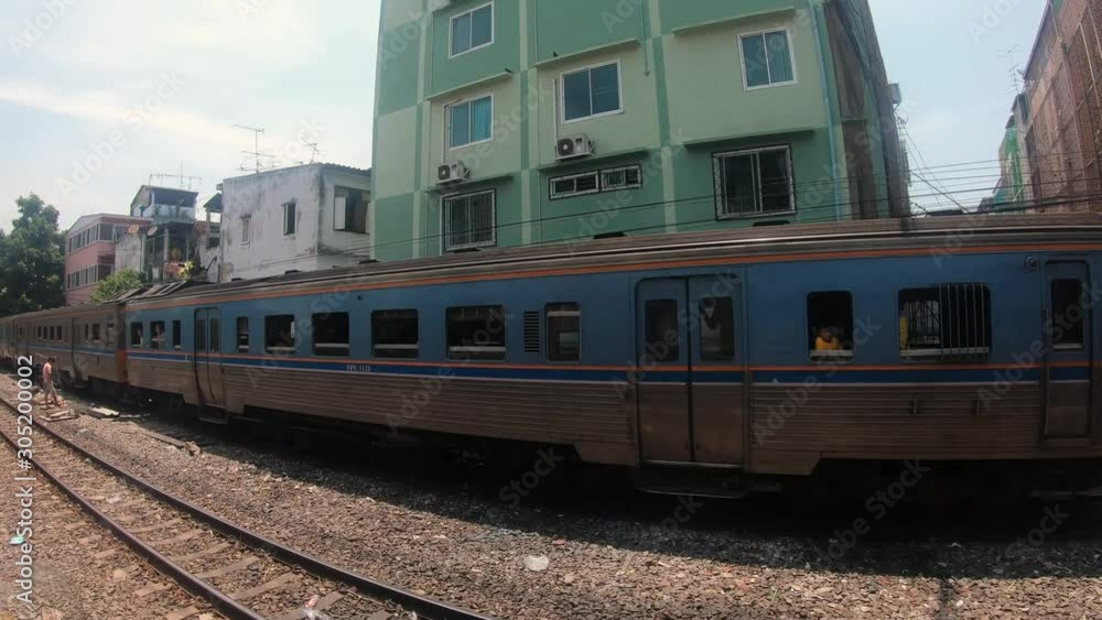 GoPro shot from a Thai Train Going Through the Suburbs of Bangkok and Passing an Idle Train