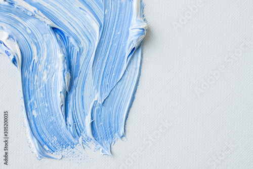 Mixing blue and white paint on canvas
