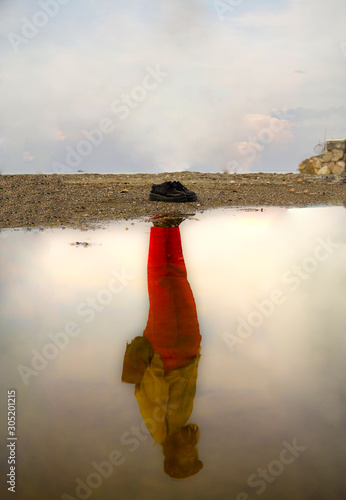 Photography Reflection of a woman and clouds on a water