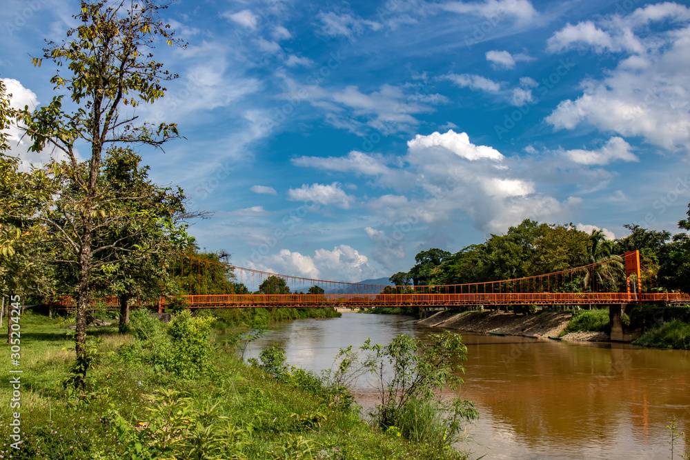 Fototapeta premium A bridge over river Nam Xong, Laos. View of nature around Vang Vieng, Vientiane Province.