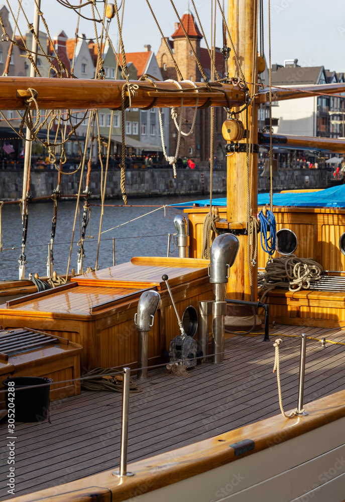 Closeup view on the wooden yacht deck moored in Gdansk marina on Motlawa River 