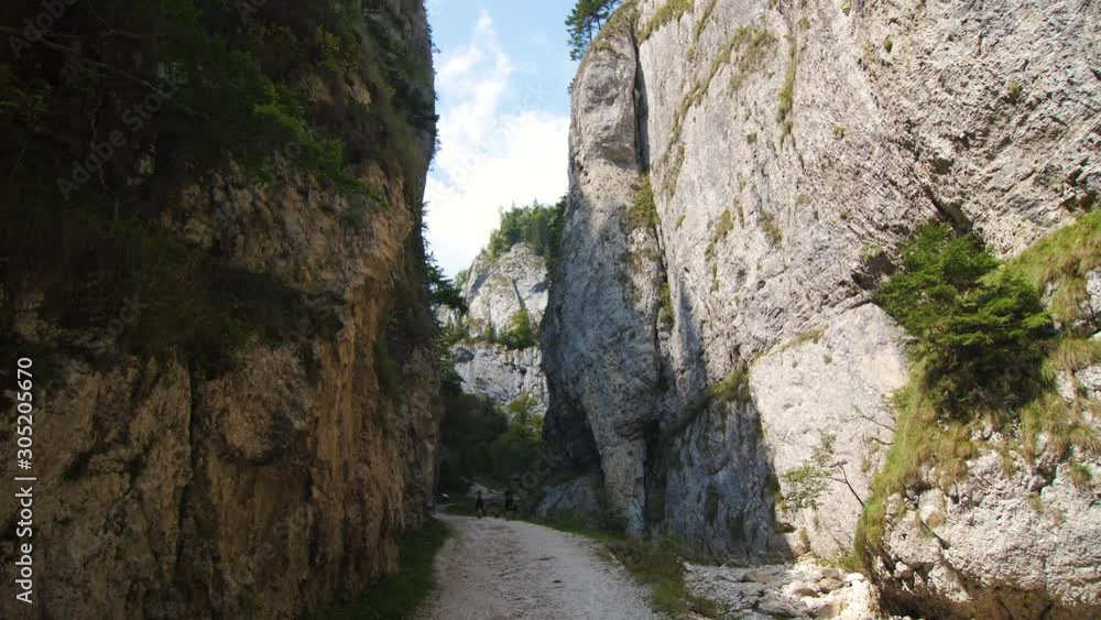 Young Couple Walking Along A Curved Mountain Road With Steep Wall Slow Motion 4k Young Couple Walking Along A Curved Mountain Road With Steep Wall Slow Motion 4k