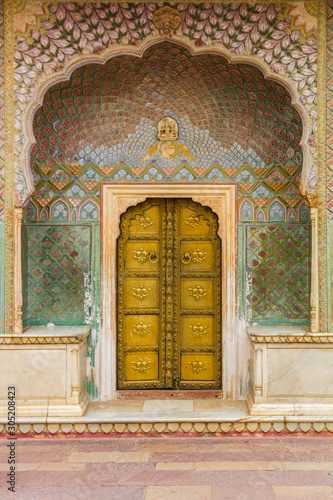 Golden door of the Peacock Gate at the city palace in Jaipur, India