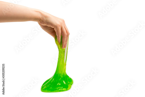 Green slime toy in woman hand isolated on white. photo