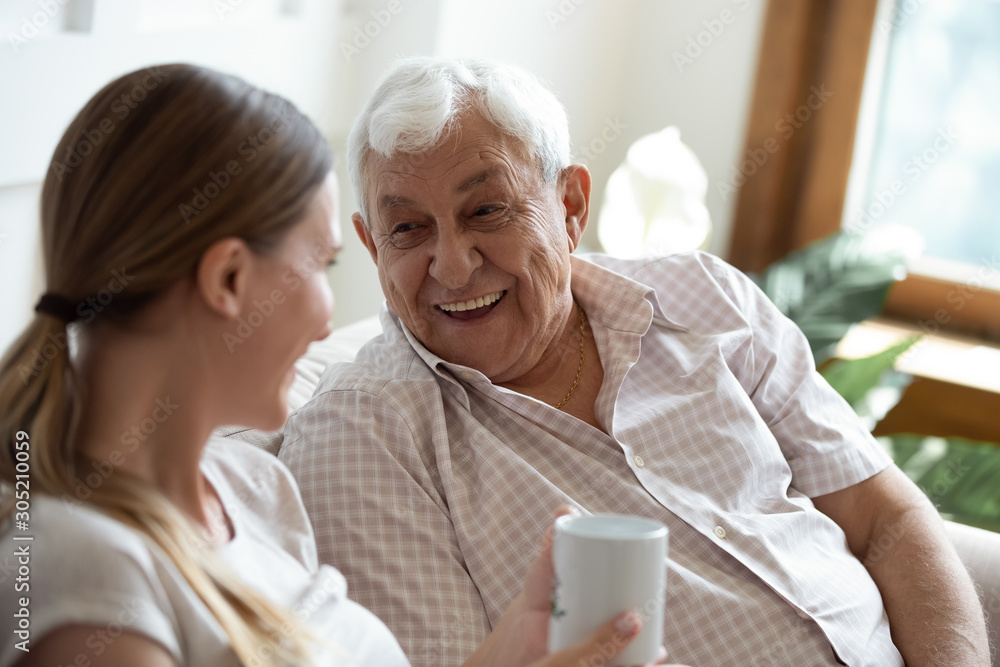 Happy old man talking with smiling grown up adult daughter. Happy old man talking with smiling grown up adult daughter.
