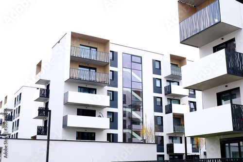 Facade of a modern apartment buildings with balcony and white walls. No people.