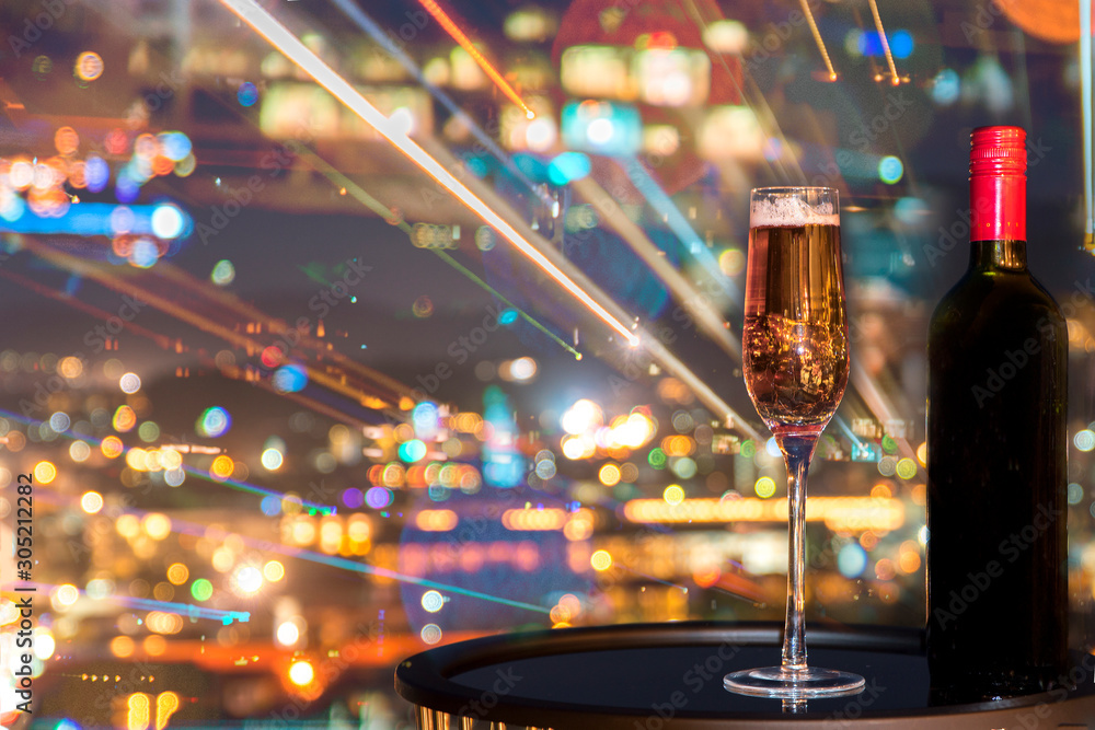 A glass of rose wine over light city blurred background and fireworks, Christmas festive celebration. End of the year, Welcome to New Year 2019. Good long holiday vacation with new thing when start up A glass of rose wine over light city blurred background and fireworks, Christmas festive celebration. End of the year, Welcome to New Year 2019. Good long holiday vacation with new thing when start up