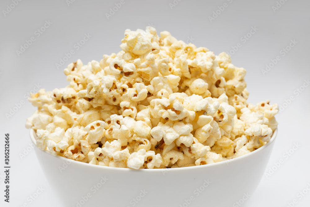 Popcorn in white big bowl isolated on white background