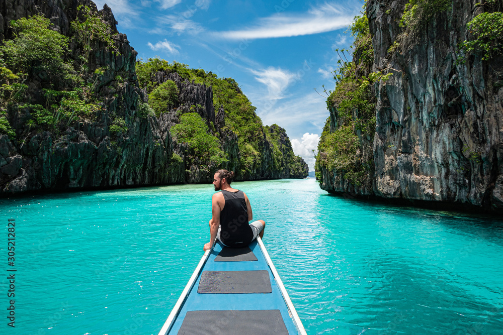 Palawan, Philippines, Traveler on Boat Deck Exploring Natural Sights Around El Nido - obrazy, fototapety, plakaty 