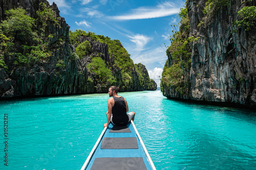 Palawan, Philippines, Traveler on Boat Deck Exploring Natural Sights Around El Nido © R.M. Nunes
