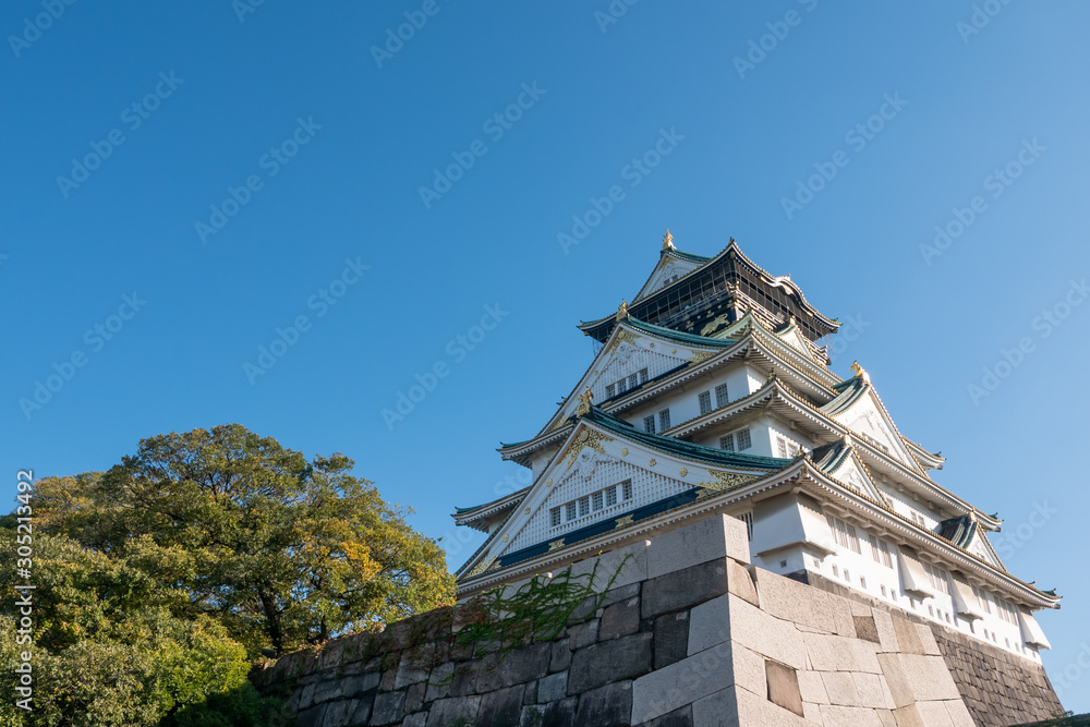 Osaka Castle in Osaka with autumn leaves. Japan Travel Concept Osaka Castle in Osaka with autumn leaves. Japan Travel Concept