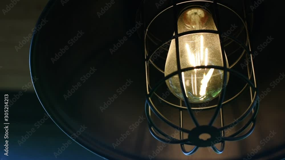 Close up incandescent lamp shining, Yellow light of lamp hang on ceiling Close up incandescent lamp shining, Yellow light of lamp hang on ceiling
