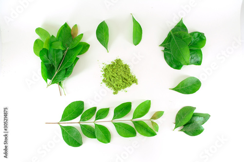 Mehendi or Heena leaves,branch and powder isolated on white background. photo