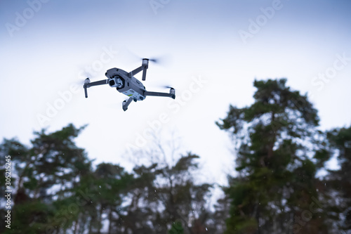 A camera drone flying in the air