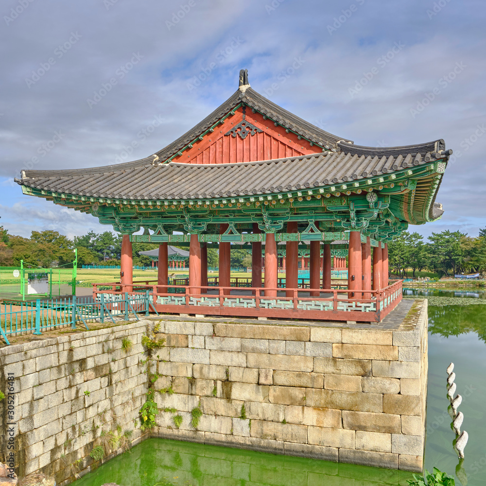 Scenic view of Donggung Palace and Wolji Pond in national park in Gyeongju in South Korea. Beautiful summer cloudy look of traditional asian style building in middle of pond in Republic of Korea. Scenic view of Donggung Palace and Wolji Pond in national park in Gyeongju in South Korea. Beautiful summer cloudy look of traditional asian style building in middle of pond in Republic of Korea.