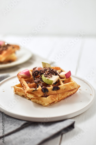 Homemade waffles with fruit and granola..