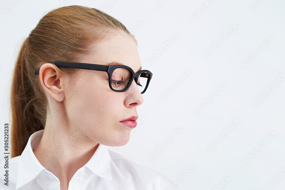 Caucasian woman wearing black frame glasses 
