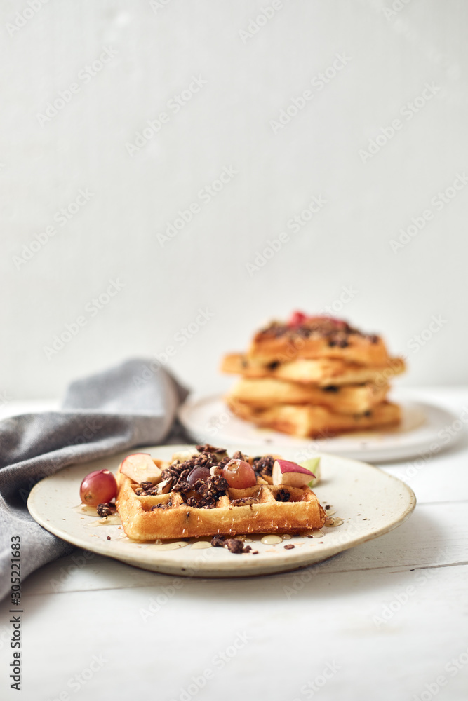 Homemade waffles with fruit and granola.. Homemade waffles with fruit and granola..