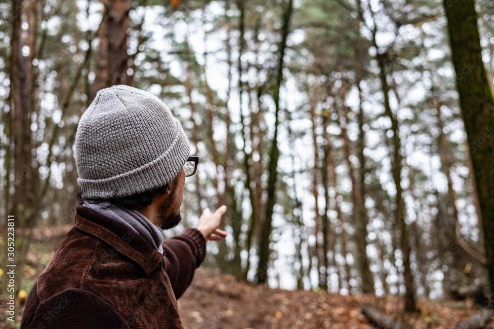 Man showing direction in the forest Man showing direction in the forest