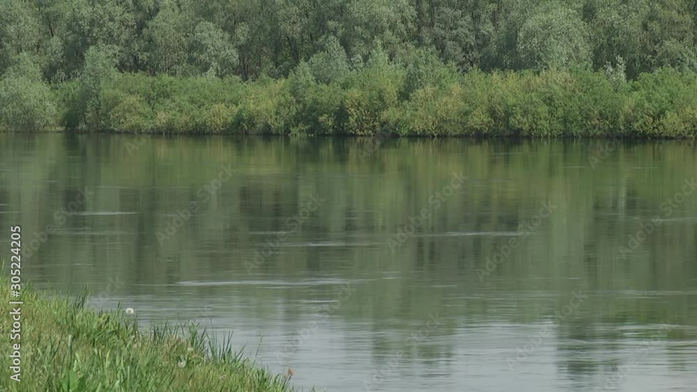 Hot day. It can be seen how the earth heated by the sun gives off heat. Landscape on the other side of the river. Nature of Central Russia. 