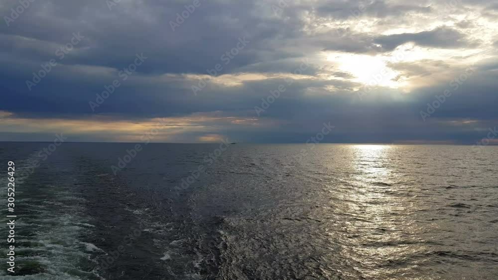 View of the ocean and sunset. Sunset over blue ocean waves. Blue ocean and sunset on the horizon. View of the ocean and sunset. Sunset over blue ocean waves. Blue ocean and sunset on the horizon.