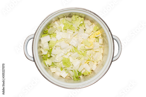 Peking cabbage, finely chopped.Peking cabbage in a saucepan on a white background. photo