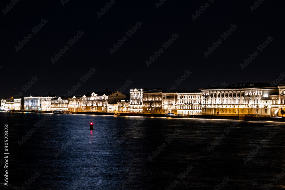 Obraz premium city night lights reflected in river