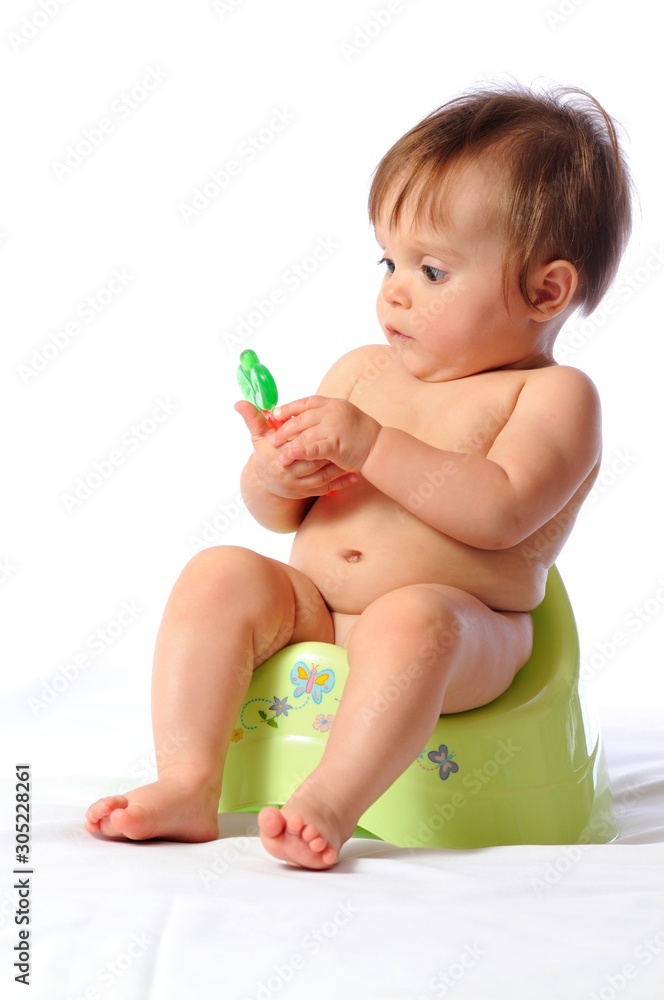 Baby sits on potty and plays toy Baby sits on potty and plays toy