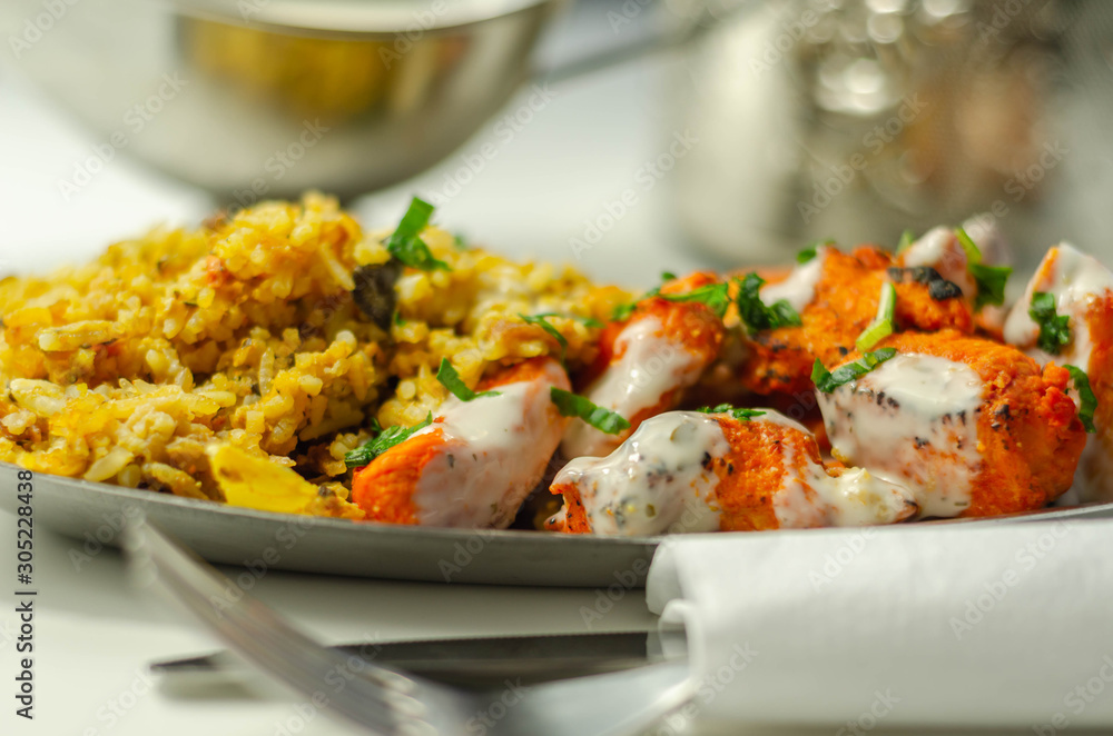 Pieces of cooked marinated chicken breast in an onion and tomato sauce with yogurt and mint and crispy fried onions layered with spiced basmati rice Pieces of cooked marinated chicken breast in an onion and tomato sauce with yogurt and mint and crispy fried onions layered with spiced basmati rice