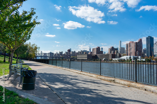 Empty Walkway at Rainey Park along the East River in Astoria Queens New York and next to the Midtown Manhattan Skyline photo