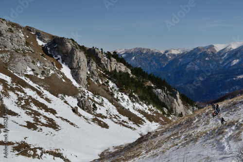 Hiking in Caucasus mountain among forest and snow