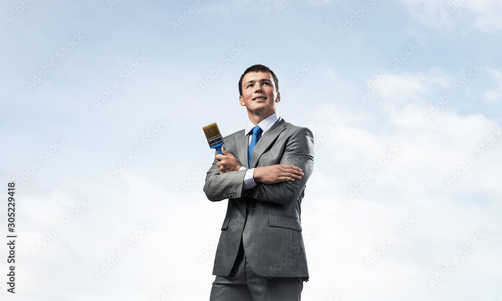 Creative businessman painter holding paintbrush Creative businessman painter holding paintbrush