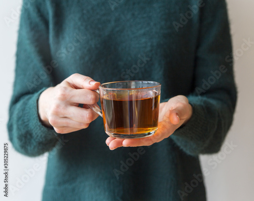 Tea glass cup in girls hand