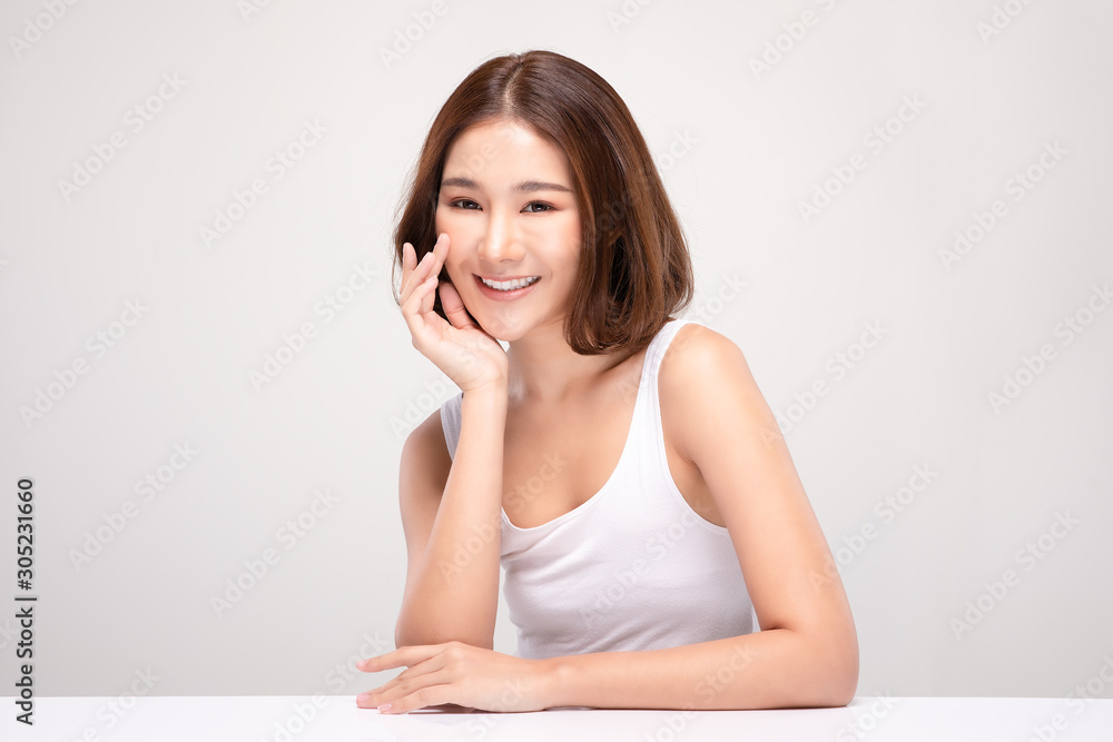 Beautiful Asian young woman touching soft cheek smile with clean and fresh skin Happiness and cheerful with positive emotional,isolated on gray background,Beauty and Cosmetics Concept Beautiful Asian young woman touching soft cheek smile with clean and fresh skin Happiness and cheerful with positive emotional,isolated on gray background,Beauty and Cosmetics Concept