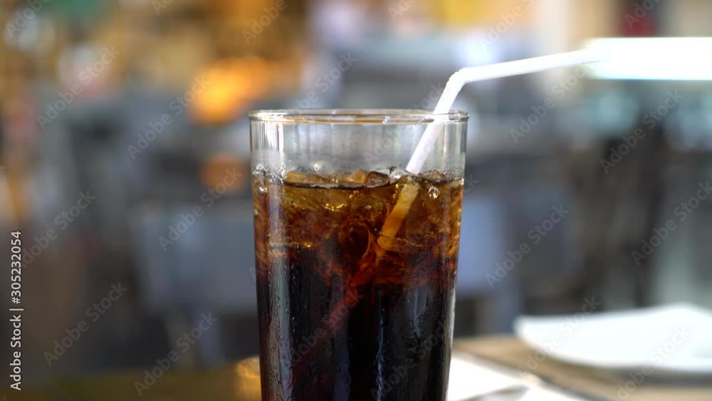 glass of iced cola in restaurant