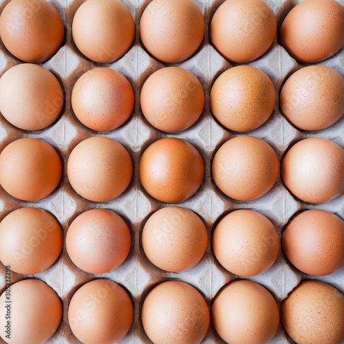 Healthy organic food, Ingredient protein breakfast, Fresh brown chicken eggs with center selective focus and blurred surrounding in paper tray pattern background