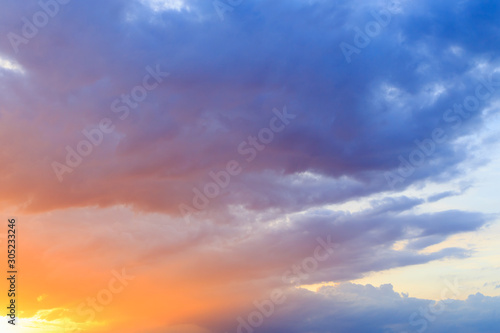 Fantasy abstract background, Gold sunlight on colorful sky and moving purple blue cloud before sunset © paahboobkk