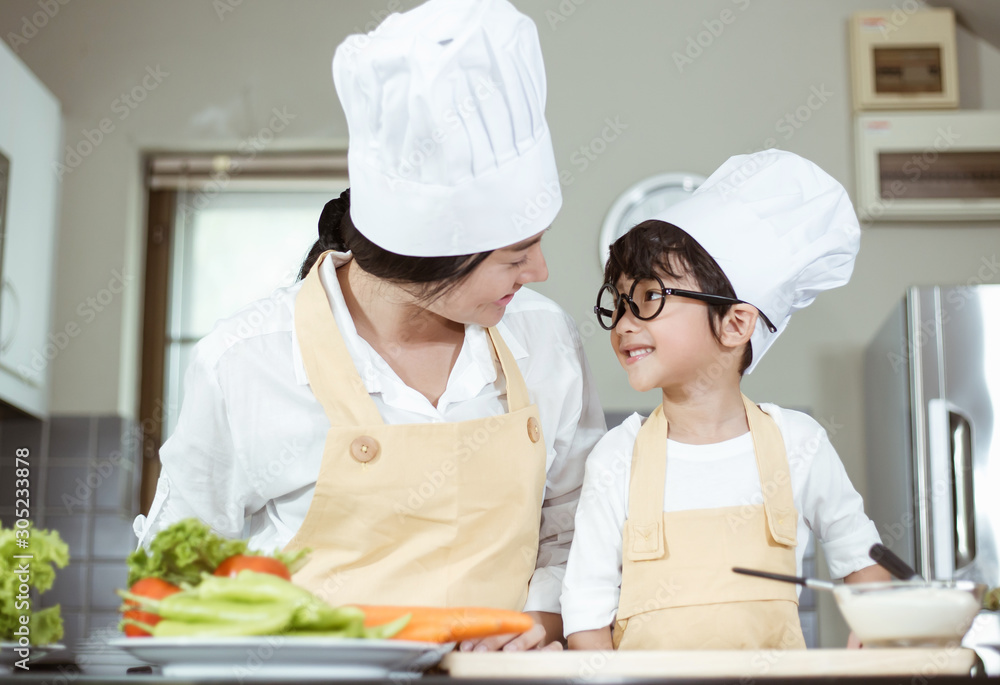 Happy family Asian woman young mother with son boy cooking healthy salad for the first time. first lesson and healthy lifestyle concept. Happy family Asian woman young mother with son boy cooking healthy salad for the first time. first lesson and healthy lifestyle concept.