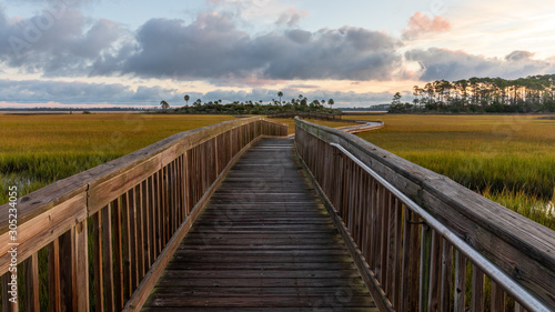 Boardwalk over the salt marsh at sunrise © Linda