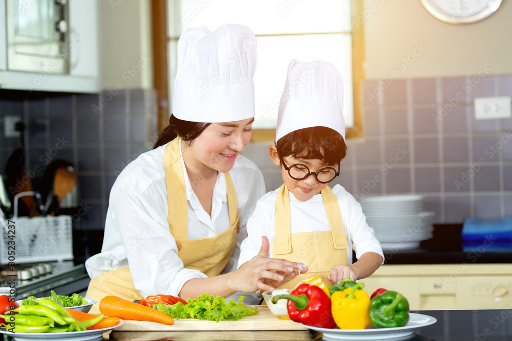 Happy family Asian woman young mother with son boy cooking healthy salad for the first time. first lesson and healthy lifestyle concept. Happy family Asian woman young mother with son boy cooking healthy salad for the first time. first lesson and healthy lifestyle concept.