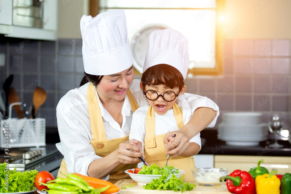 Happy family Asian woman young mother with son boy cooking healthy salad for the first time. first lesson and healthy lifestyle concept. Happy family Asian woman young mother with son boy cooking healthy salad for the first time. first lesson and healthy lifestyle concept.