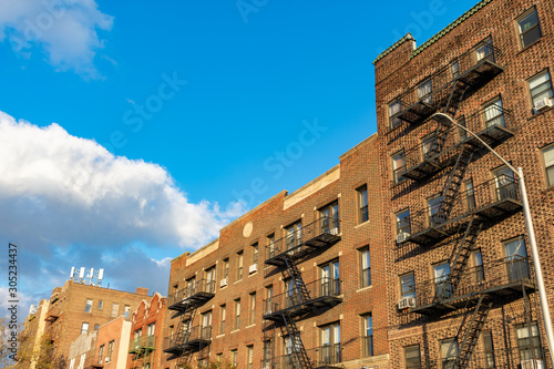 A Row of Old Brick Residential Buildings with Fire Escapes in Astoria Queens New York