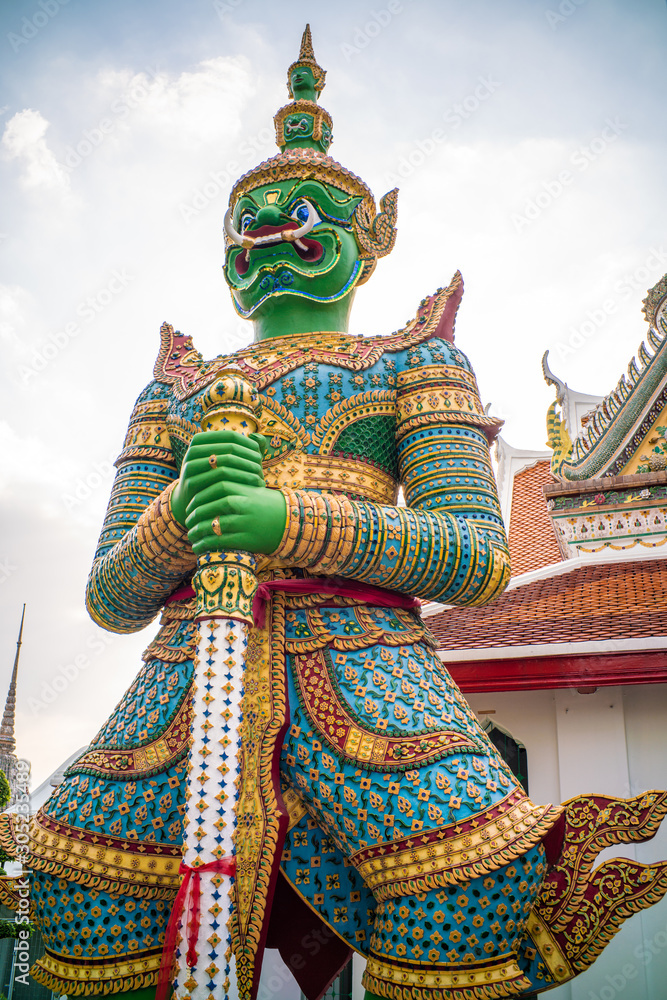 Giant stand statue in Wat Arun templeof dawn