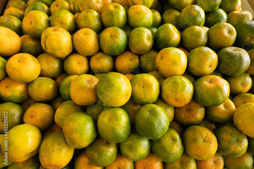 orange fruit stacked on the marketplace