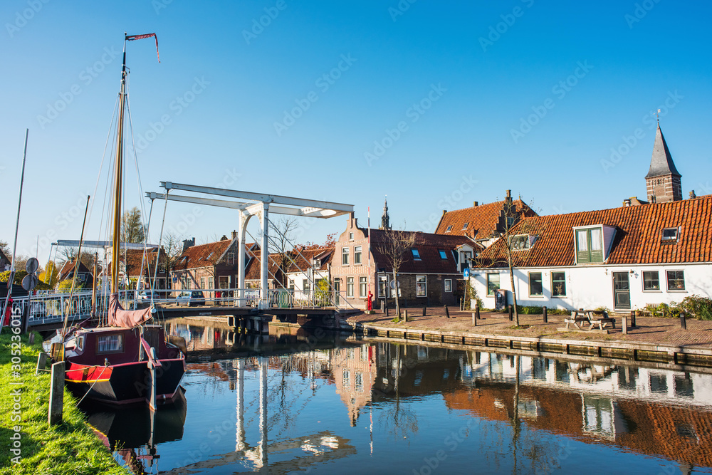 Edam old town, Netherlands. Picturesque canal with boat in Waterland district near Amsterdam. Popular travel destination and tourist attraction