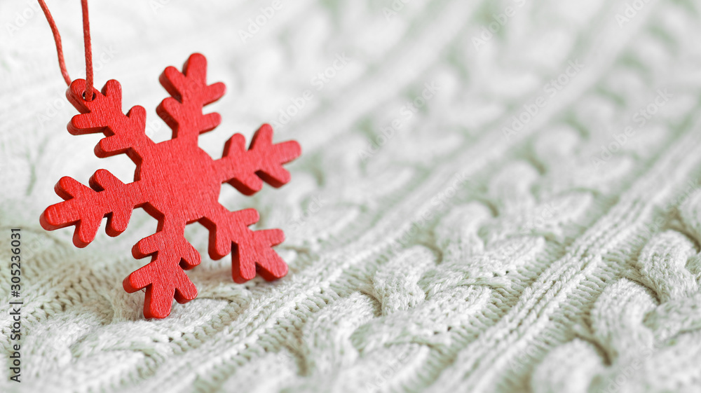 Red snowflake close-up on the white knitted background. New Year, Christmas and winter concepton the white knitted background. New Year, Christmas and winter concept Red snowflake close-up on the white knitted background. New Year, Christmas and winter concepton the white knitted background. New Year, Christmas and winter concept
