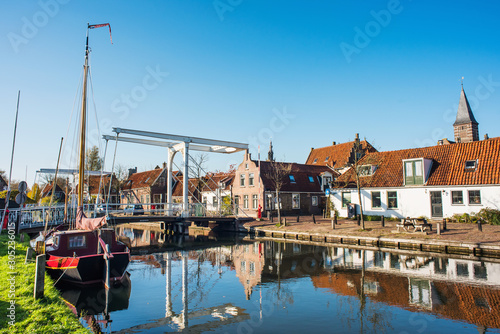 Edam old town, Netherlands. Picturesque canal with boat in Waterland district near Amsterdam. Popular travel destination and tourist attraction