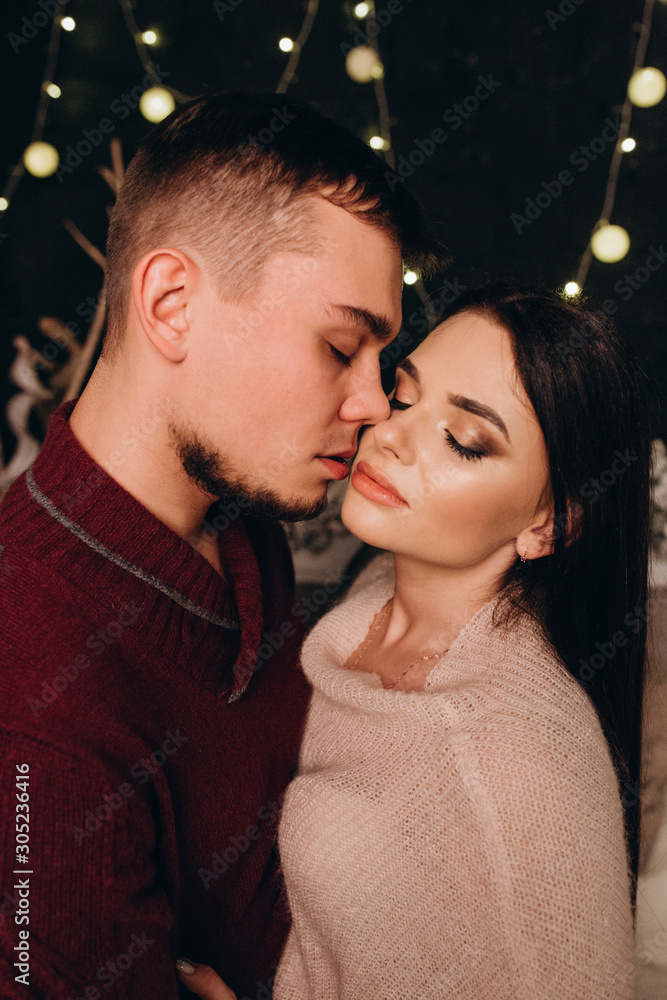 Romantic evening of a young couple. New Year's love story. Photo session of lovers in the studio. Romantic evening of a young couple. New Year's love story. Photo session of lovers in the studio.