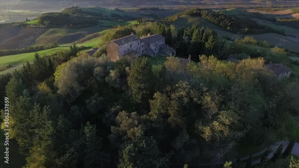 4k aerial  drone orbit flight footage over the Tuscany countryside small ancien village of Gello near Volterra.